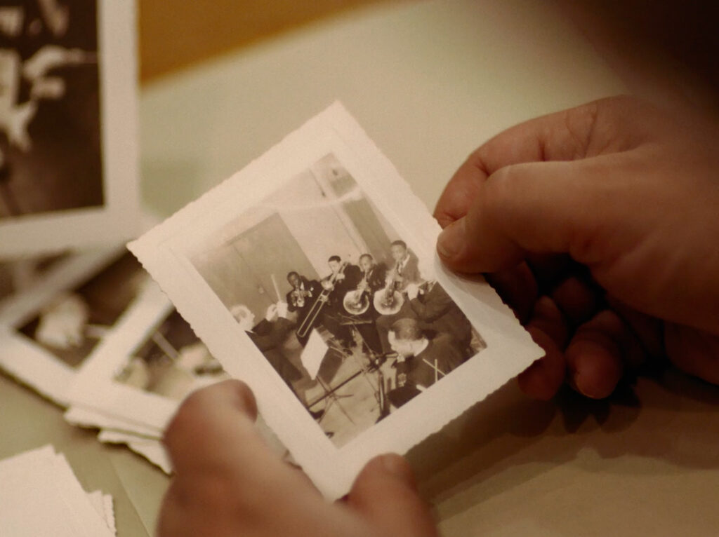 Hands holding a photograph of the Negro Symphony Orchestra